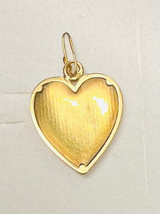 Pendentif Augis d’amour « + qu’hier - que demain » en or 18 carats serti de rubis calibrés.